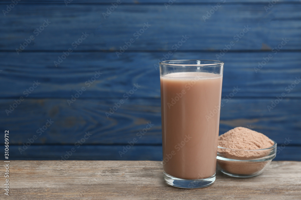 Protein shake and powder on wooden table, space for text Protein shake and powder on wooden table, space for text