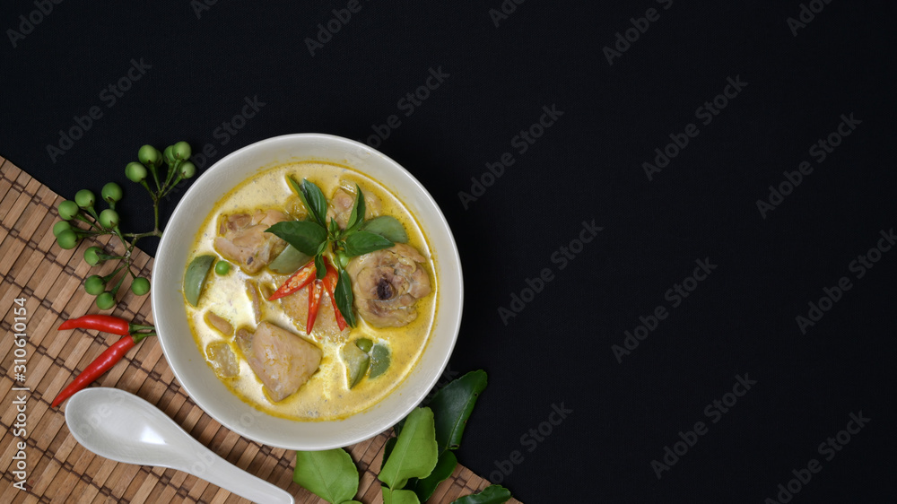 Thai cuisine concept : chicken green curry and ingredients on black desk background Thai cuisine concept : chicken green curry and ingredients on black desk background