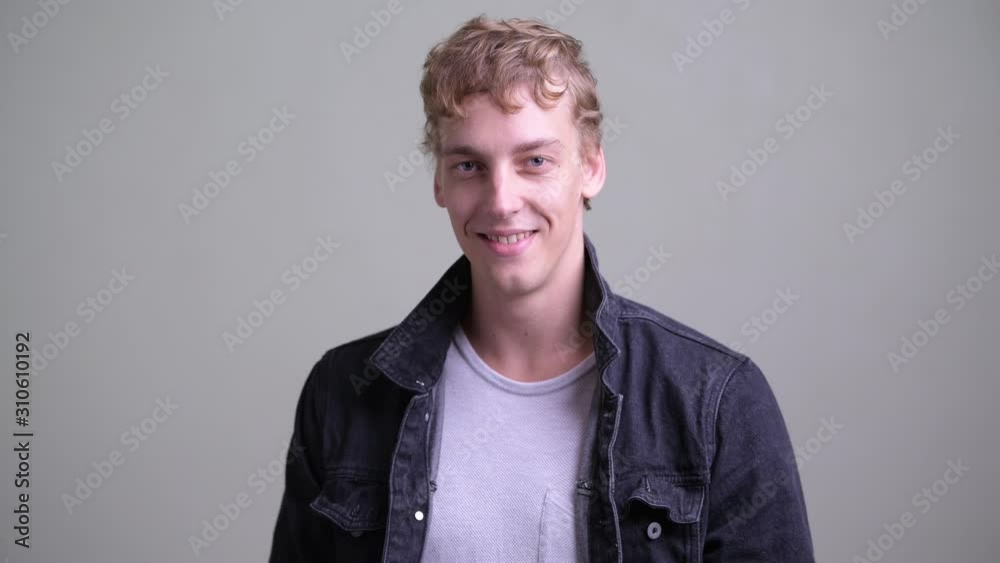 Face of happy young handsome man with curly hair smiling Face of happy young handsome man with curly hair smiling
