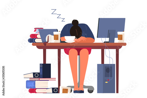 Exhausted businesswoman sleaping in the office putting her head on the desk. photo