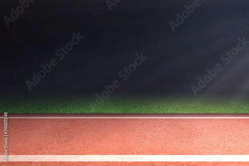 Running track with green grass and light