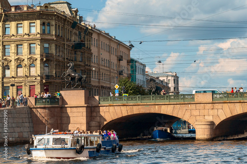 tourist ship on the Neva in St. Petersburg against the background of Anichkov bridge photo