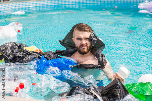 Ecology  plastic trash  environmental emergency and water pollution - shocked man swim in a dirty swimming pool