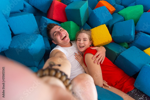 Self portrait of funny comic couple shooting selfie on trampoline