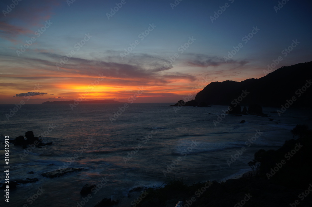 sunset and sunrise are the natural beauty at the end of the night and at dusk giving the perfect color to the sky so the clouds look beautiful to be seen with the beach set against a mountain. sunset and sunrise are the natural beauty at the end of the night and at dusk giving the perfect color to the sky so the clouds look beautiful to be seen with the beach set against a mountain.
