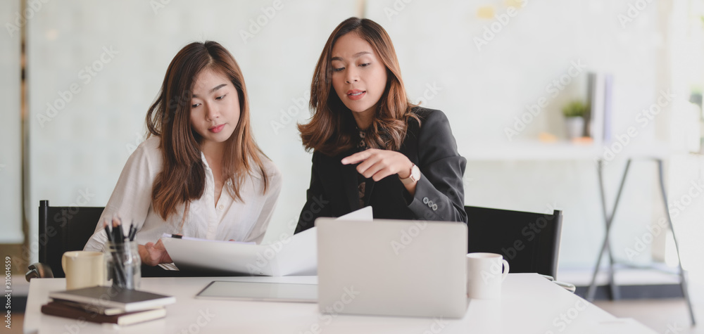 Young beautiful businesswoman explaining her ideas to her coworker in modern office Young beautiful businesswoman explaining her ideas to her coworker in modern office