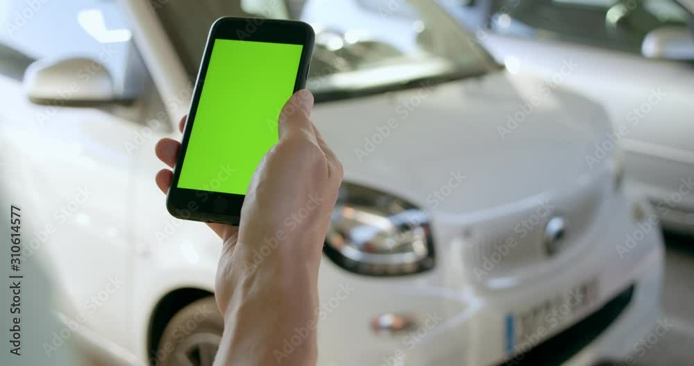 Man opens rental electric sharing car with phone Man opens rental electric sharing car with phone