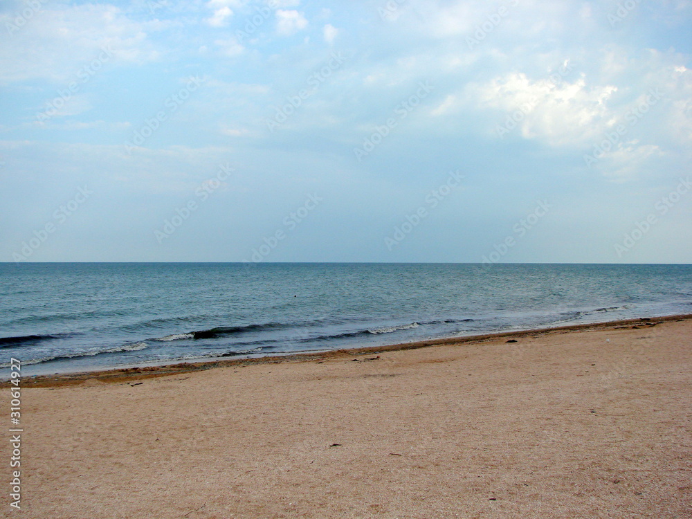 Panorama of the coast of the Azov Sea on a background of cloudy evening sky at sunset. Panorama of the coast of the Azov Sea on a background of cloudy evening sky at sunset.