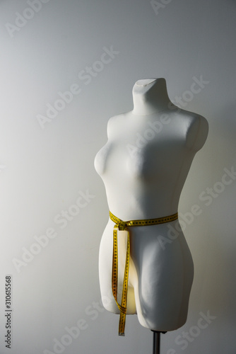 Tailor dummy with measuring tape