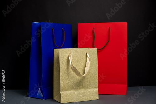 Close up of three color Shopping bag isolated on black background. Packaging template mockup. Delivery concept advertising mock. Shopping Concept