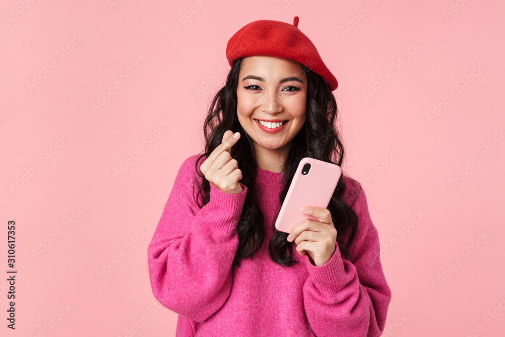 Image of asian girl showing money counting gesture and holding smartphone Image of asian girl showing money counting gesture and holding smartphone