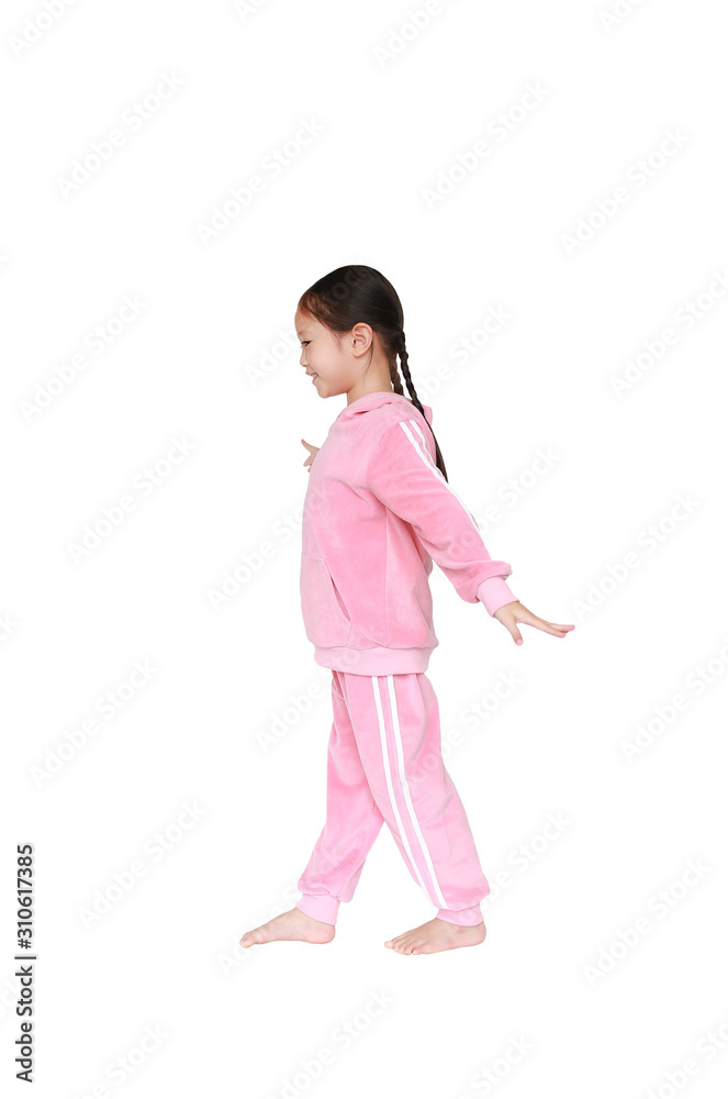 Portrait of smiling little Asian kid girl in pink tracksuit or sport cloth doing exercises isolated on white background. Portrait of smiling little Asian kid girl in pink tracksuit or sport cloth doing exercises isolated on white background.