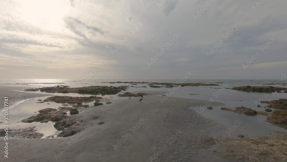 Varied coastline, yellow rocks, sand and shiny sea water Varied coastline, yellow rocks, sand and shiny sea water