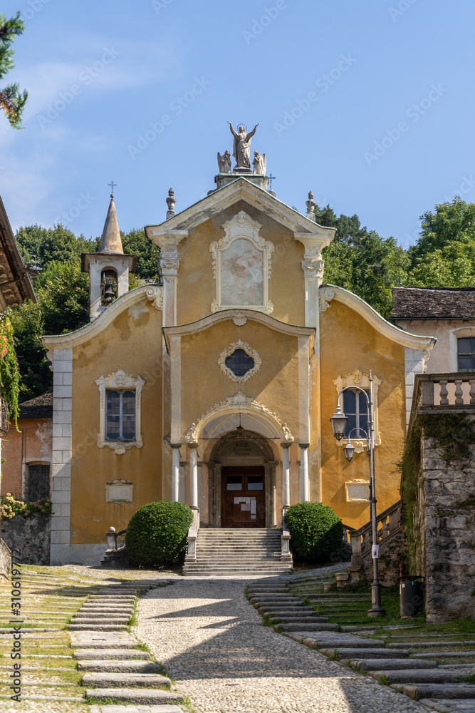 The yellow facade of the Church of the Holy Cross, in Orta San Giulio, Piedmont, Italy