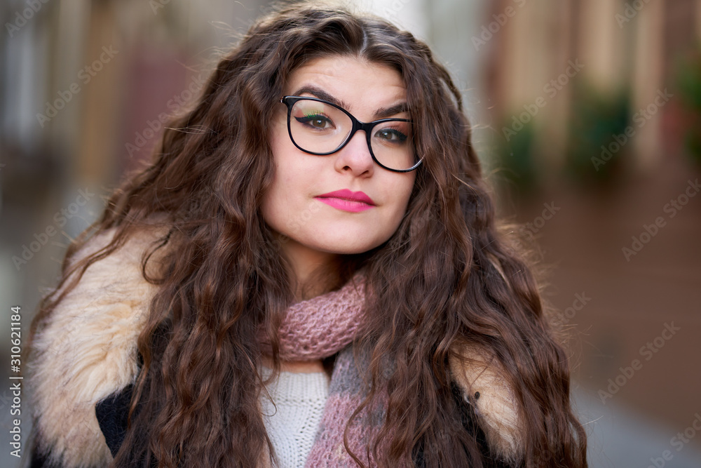 Curly haired young woman outdoor, closeup Curly haired young woman outdoor, closeup