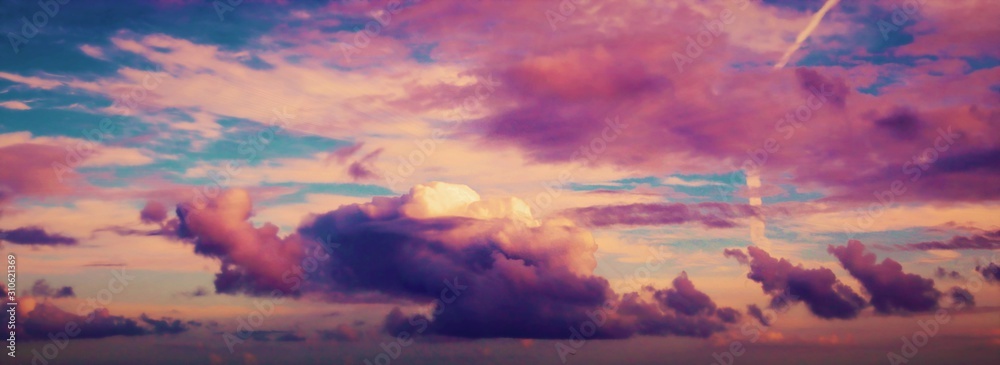 Sunset with fluffy pink clouds and colourful blue sky.