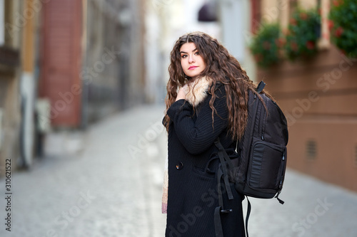 Young tourist with backpack in old town