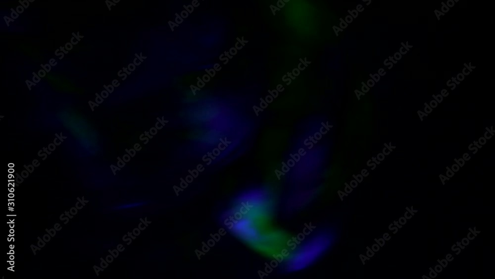 Clouds of smoke with rotation move illuminated by colored beams of a disco lamp. Tongues of smoke in the light of a lantern.