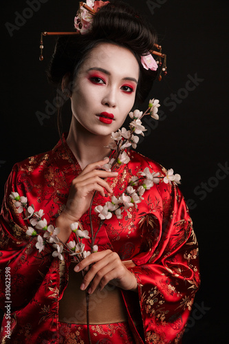 Valokuva Image of brunette geisha woman in japanese kimono with sakura tree