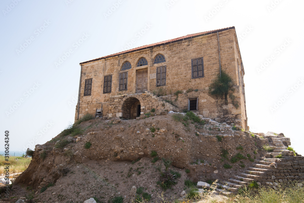 View of a traditional Lebanese house among the Roman ruins of Byblos. Byblos, Lebanon - June, 2019