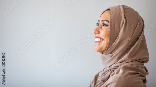 Beautiful muslim woman posing and smiling. Portrait of a beautiful muslim woman wearing hijab. Beautiful young Muslim woman wearing a hijab on her head