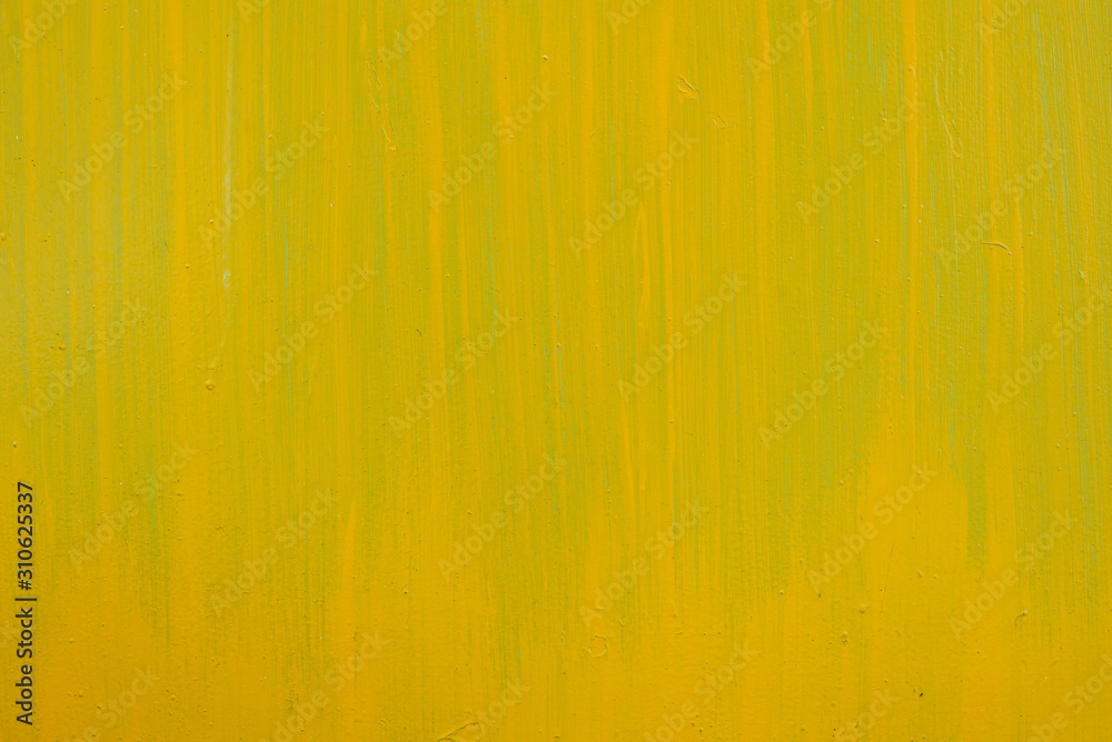 Yellow paint strokes on a metal sheet. Copy space