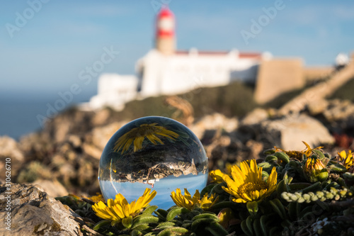 View of the lighthouse through crystal globe at Cape St. Vincent.
