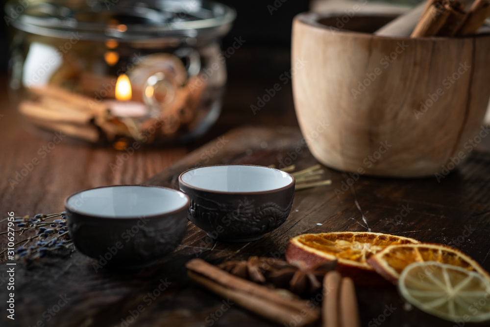 Fototapeta premium Ceramic cups with herbs for Chinese tea ceremony on dark background.