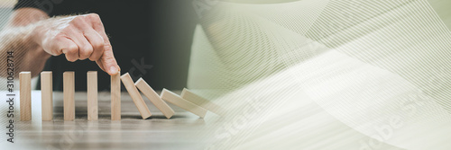 Concept of business control by stopping domino effect; panoramic banner
