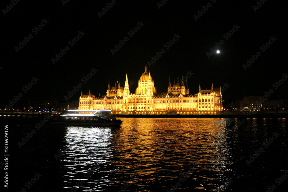ブダペスト　ドナウ川遊覧船から見た満月と国会議事堂、前を横切る遊覧船