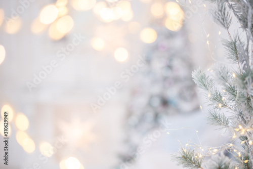 Light silver Christmas background with lights and Christmas tree. Space for text