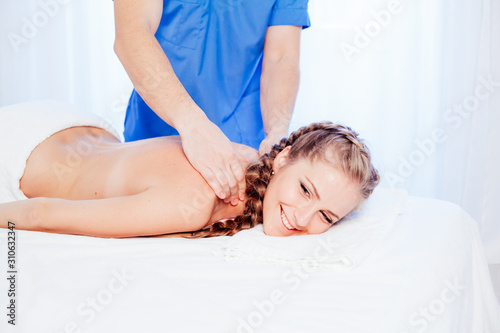 the doctor makes a back massage and body girl spa treatments