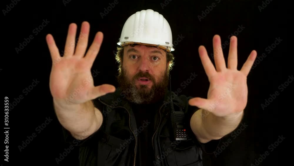Concept idea: Bearded construction worker tries to stop someone with hand signals Concept idea: Bearded construction worker tries to stop someone with hand signals