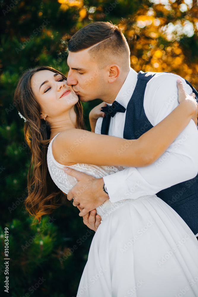 Portrait of couple in hugs on background of autumn trees Portrait of couple in hugs on background of autumn trees