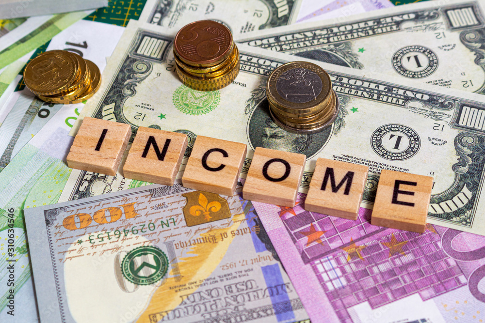 word text income on the money banknotes background word text income on the money banknotes background
