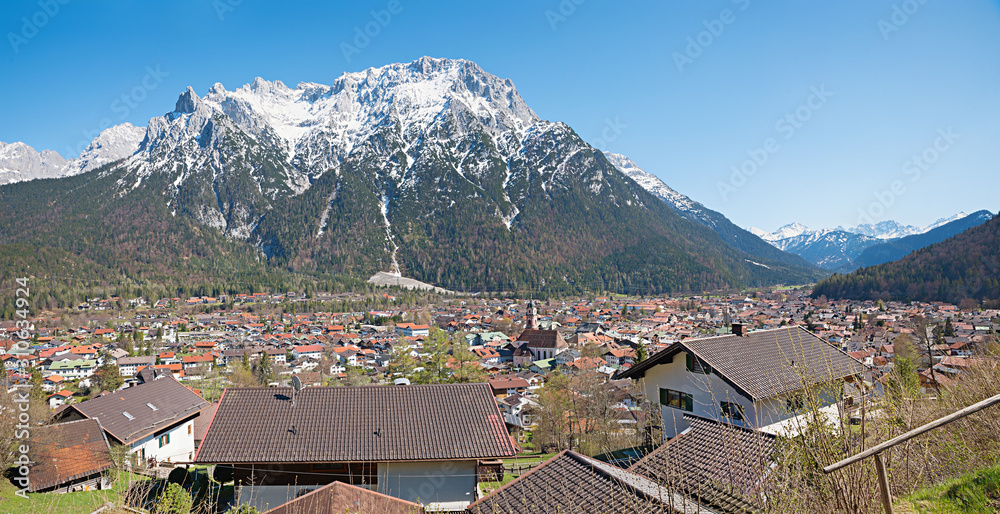 view to spring landscape spa town mittenwald and karwendel mountains with snow, upper bavaria