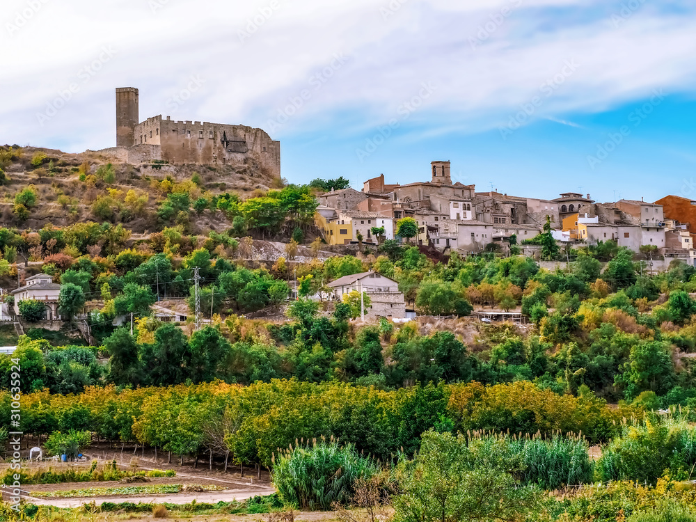 Ancient stone hilltop village in Catalonia (Spain). Traditional Catalan autumn rural landscape with medieval houses, castle and chapels among olive fields