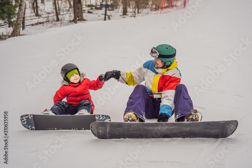 Snowboard instructor teaches a boy to snowboarding. Activities for children in winter. Children's winter sport. Lifestyle
