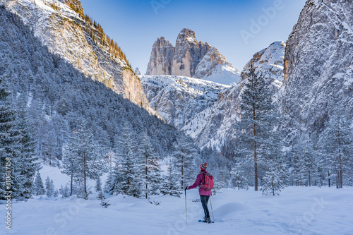 Valokuva active senior woman snowshoeing in  spectacular Hoehlenstein Valley under the fa