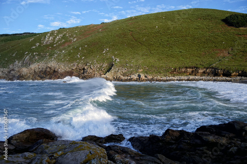Moreira beach in Muxia, Costa da Morte, Galicia, Spain. Waves Crashing Against the Rocks. This beach is one of the wildest spots on the hiking trail called 