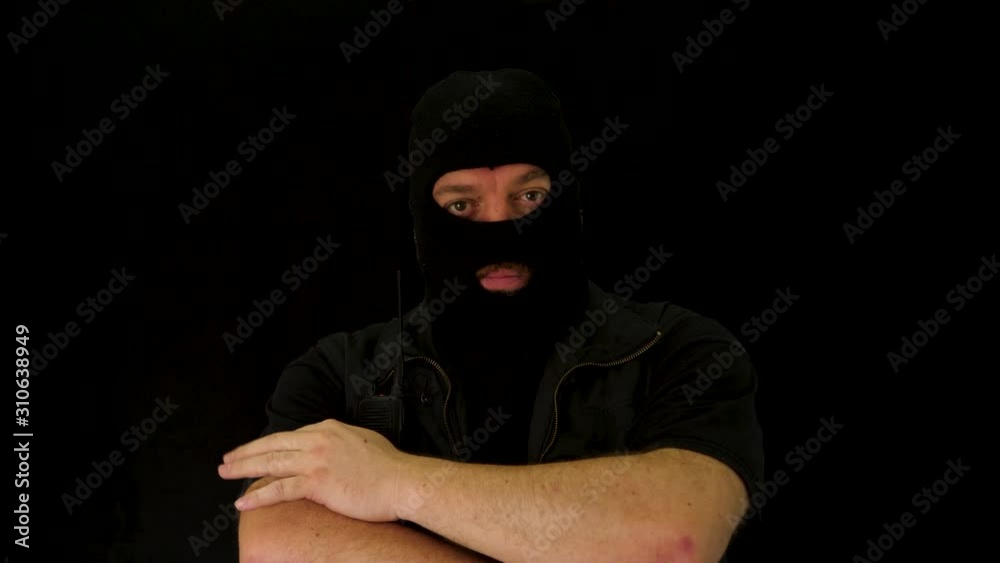 Concept idea: Man with balaclava looking at the camera Concept idea: Man with balaclava looking at the camera