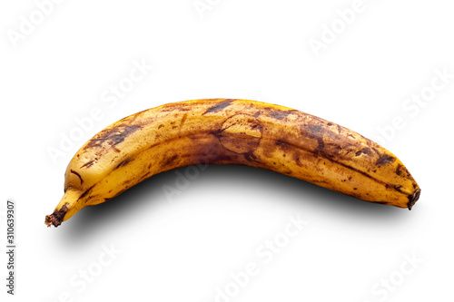 Overripe spoiled banana on a white surface. Yellow banana isolated on a white background.