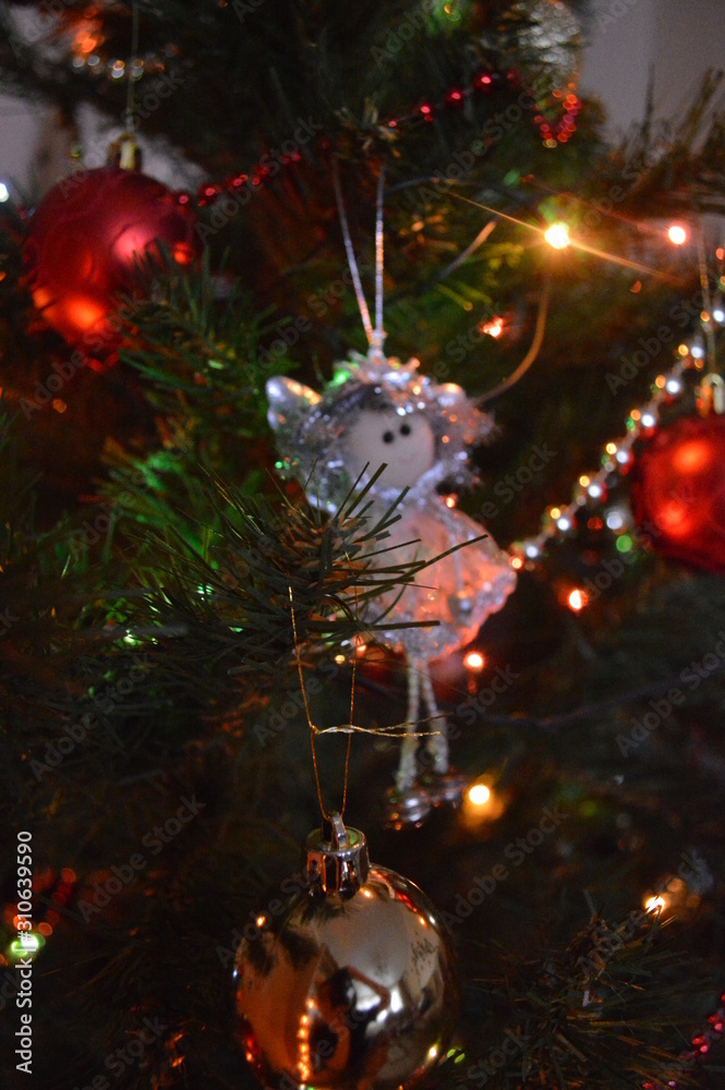 Toys on christmas tree with bright lights