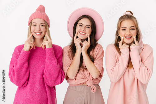 Image of pretty girls in pink clothes showing their smile with fingers