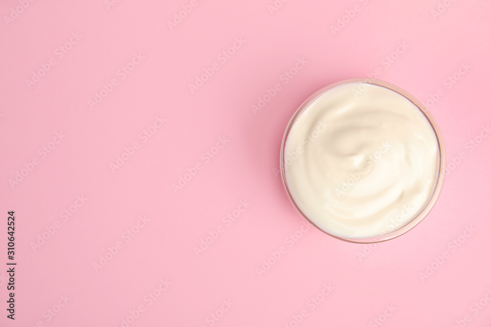 Tasty organic yogurt on pink background, top view. Space for text Tasty organic yogurt on pink background, top view. Space for text