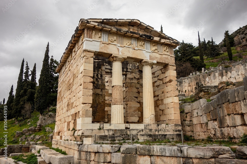 The ancient Delphi in Greece with Treasury of Athenians in cloudy weather with perspective view