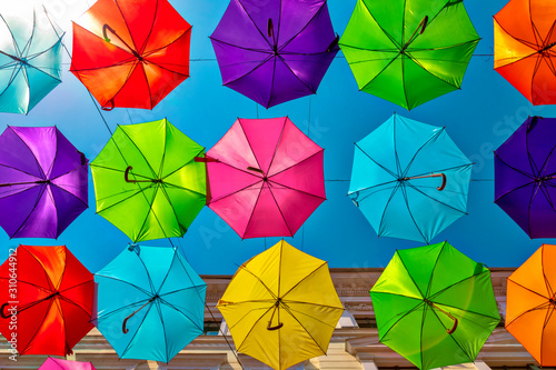 Looking up at the colorful umbrellas. Festive street decoration.