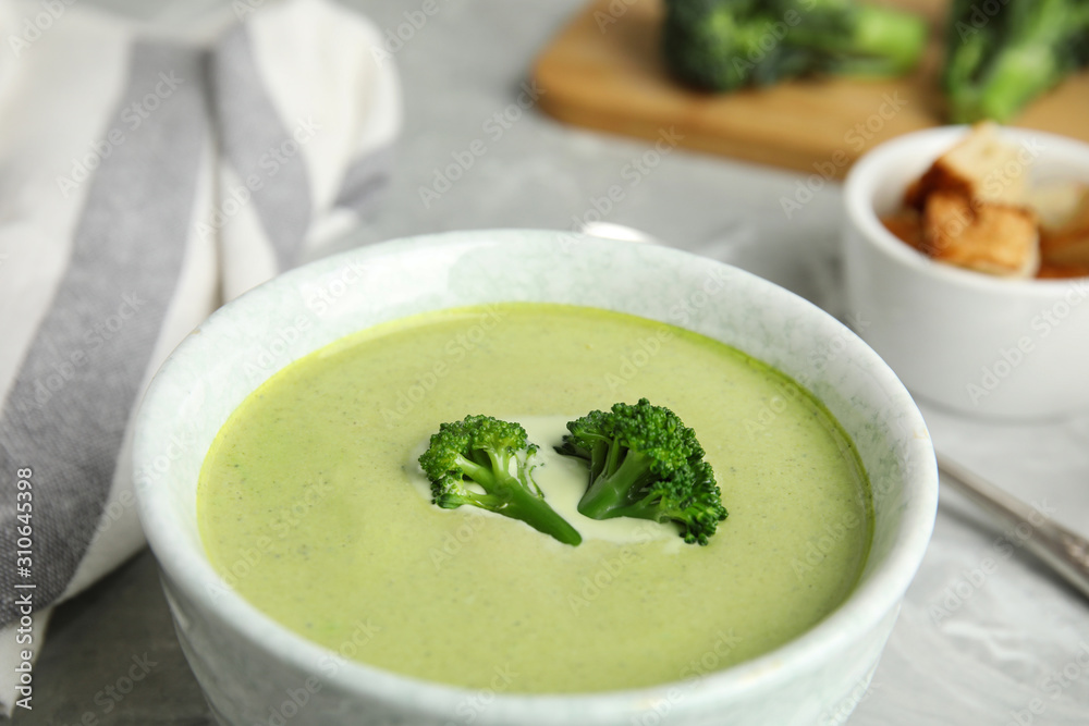 Bowl of delicious broccoli cream soup on table, closeup Bowl of delicious broccoli cream soup on table, closeup