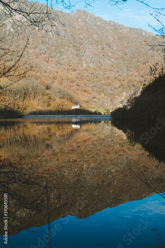 Lonely house reflection on a calm lake © Eneko Aldaz