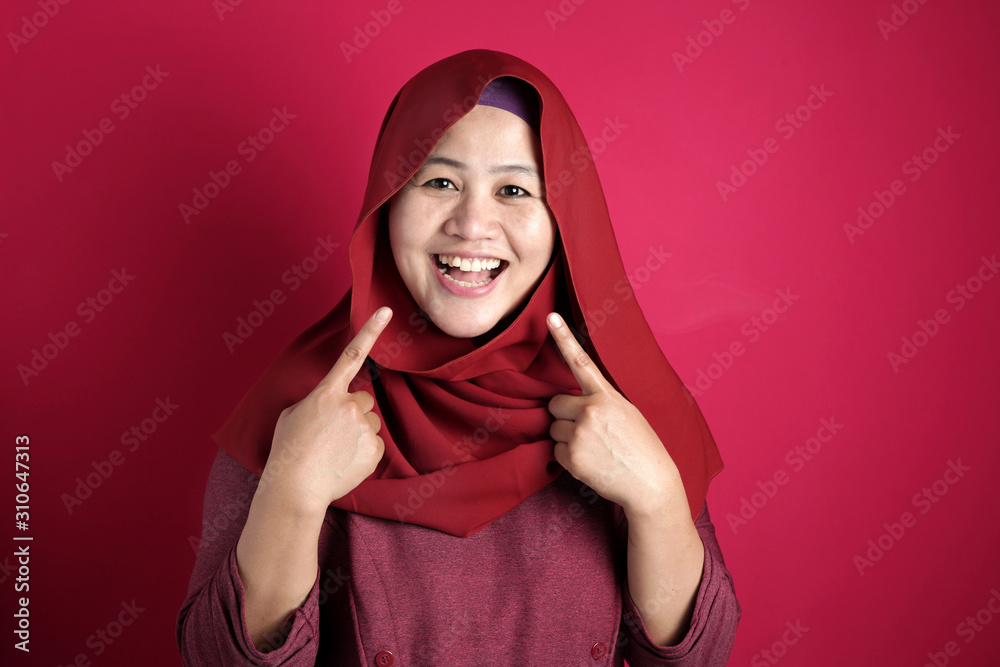 Confident Muslim Lady Smiling and Pointing Herself Confident Muslim Lady Smiling and Pointing Herself